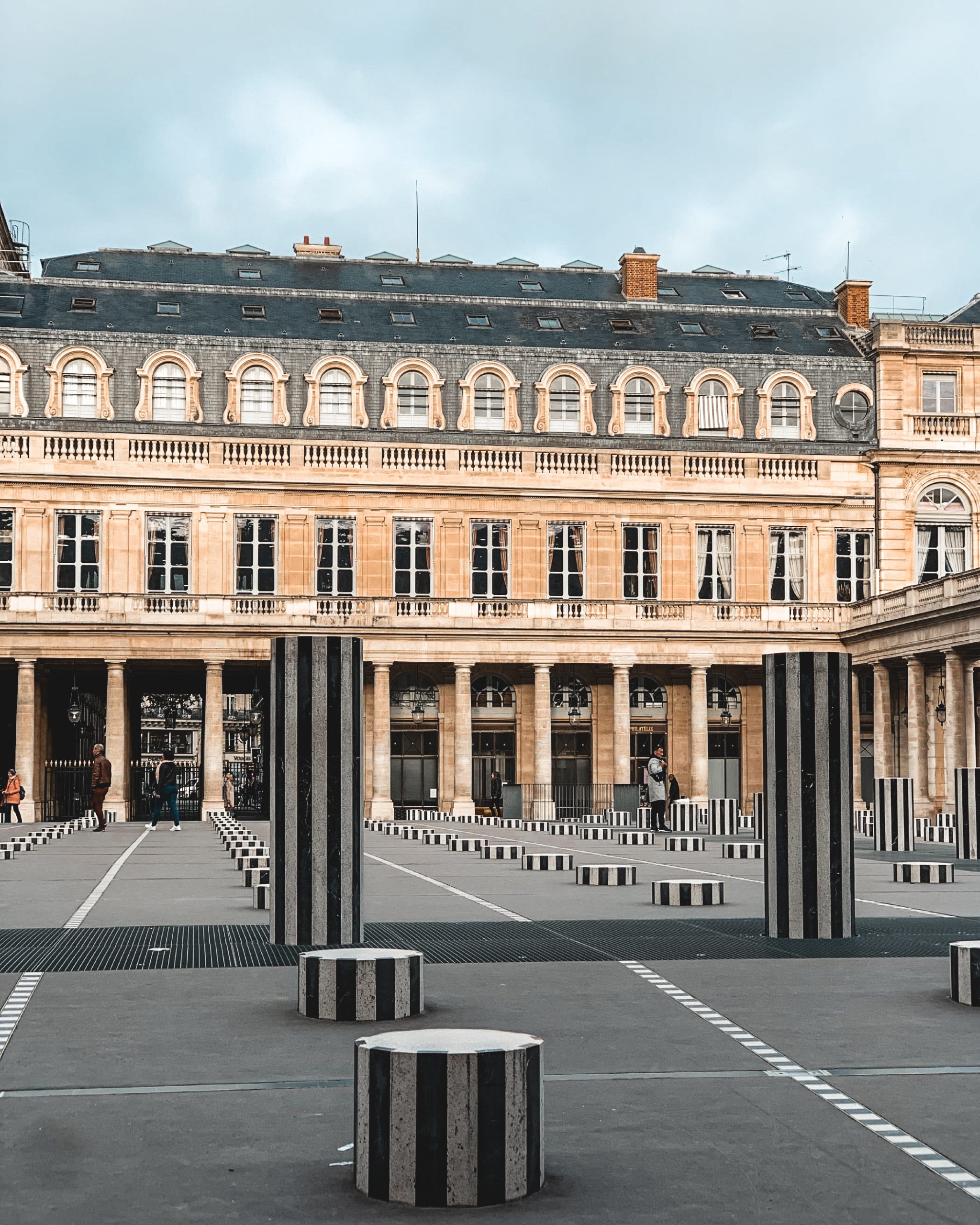 Travel girl, visiting Paris, famous place to be, Palais royal, colonnes de Buren